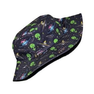 Close-up of black bucket hat featuring green alien and UFO pattern in cotton canvas