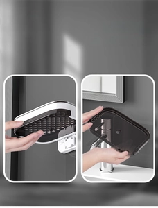Detail of detachable wall-mounted soap box featuring a black transparent drainage drawer