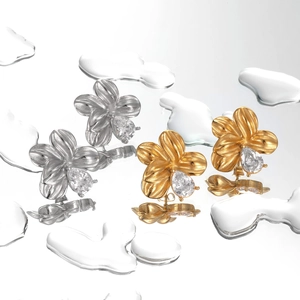 Floral titanium steel stud earrings with teardrop zircon on reflective water surface