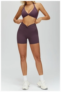 Front view of purple twisted halter sports bra and high-waisted shorts yoga set