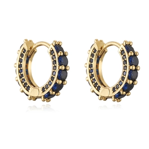 Detail of gold huggie earrings with pave dark blue and black cubic zirconia stones