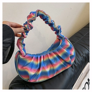 Detail of pleated cloud bag with rainbow gradient finish and silky satin texture