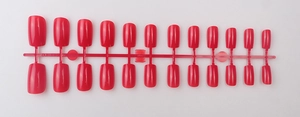 Detail view of 24 pieces of long square glossy magenta press-on nails on a red holder