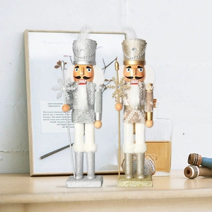 Detail of 38cm wooden nutcracker soldiers in gold and silver with glitter finish