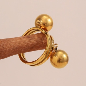 Macro shot of 18K gold-plated double-band ring with dual spherical bead charms