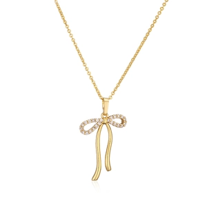 Delicate gold bow necklace with micro-p鑲 zircοnia pendant and elegant metal ribbon tassels