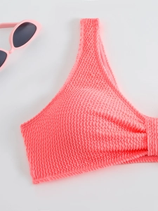 Close-up of pink waffle texture fabric bikini top with matching sunglasses decor