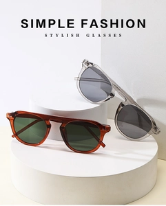 Close-up of retro sunglasses with metal rivet accents on geometric display stands