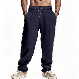 Detail of navy blue corduroy pants featuring white side stripes and drawstring waistband