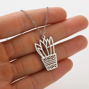Detailed macro view of silver stainless steel potted plant pendant with hollow design