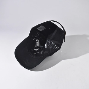 Detail of black cotton baseball cap interior with sweatband and adjustable metal buckle
