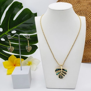 Gold monstera leaf jewelry set with natural abalone shell inlay earrings and necklace