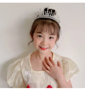 Close-up of a silver princess crown headband with sparkling rhinestones for young girls