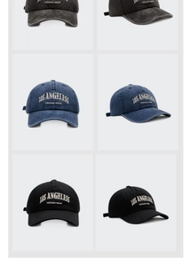 Detail of vintage washed baseball caps with Los Angeles embroidery in dark grey and black