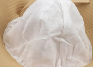 Detail of the breathable white cotton lining and precise stitching inside the sun hat