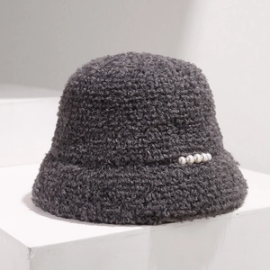 Detailed plush texture of dark grey faux fur bucket hat with white pearl accents