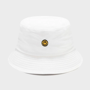 White cotton bucket hat featuring a yellow smiley face embroidery for outdoor sun protection