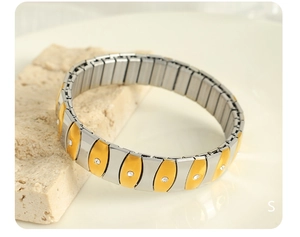 Detail of two-tone stretch bracelet with crystal-inlaid links and polished finish