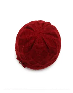 Top view of red knit hat showing thick textured weave pattern and bead accents