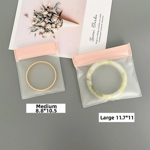 Frosted EVA jewelry storage pouches with pink zippers showing medium and large sizes