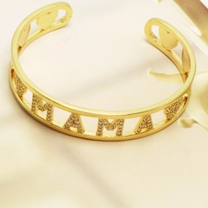 Golden MAMA open cuff bracelet with sparkling white zircons and hollow heart accents