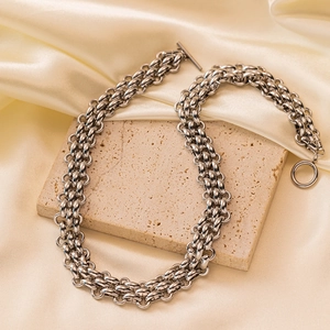 Heavy industrial style silver link chain necklace with OT buckle on beige stone