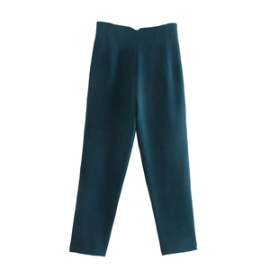 Detail view of high-waisted deep teal trousers showing straight-leg cut on white background