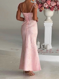 Close-up of pink jacquard fabric evening dress featuring open back with tie-up detail