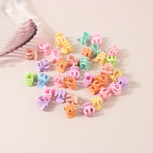 Mini floral hair clips set in colorful macaron colors scattered on beige background