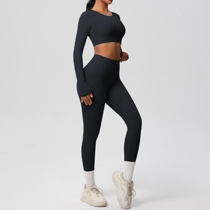 Detail view of seamless black yoga set with long sleeve crop top and high waist leggings
