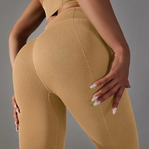 Macro detail of ginger high-waisted yoga pants with honeycomb texture and ergonomic seams