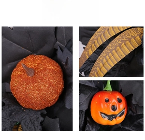 Detail of Halloween wreath featuring glitter pumpkins and decorative speckled feathers