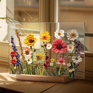 Detail of colorful mixed media floral art set in a transparent acrylic desktop frame