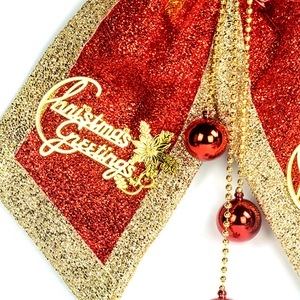 Red and gold Christmas tree bow ornament with golden Christmas Greetings lettering detail