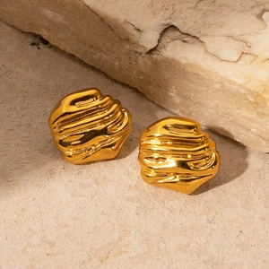 Irregular 18k gold plated geometric earrings with natural texture on beige stone