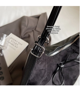 Detailed macro view of black matte suede texture with adjustable silver metal strap buckle