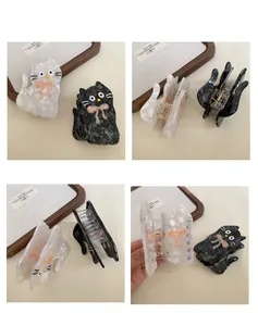 Detailed views of acetate cat hair claws with marble texture and pink bow accents
