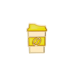 Close-up of a golden coffee cup enamel pin with a coffee bean pattern on white background