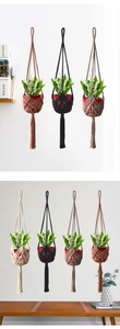 Detailed macro texture of hand-woven macrame plant hangers in various earthy color tones