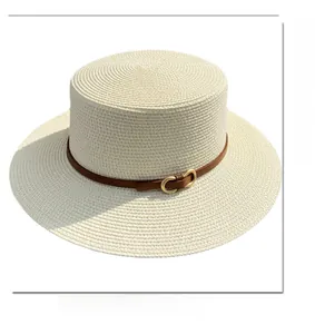 Detail of flat top boater hat with fine straw weave and brown leather horsebit strap