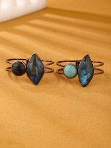 Macro shot of vintage bronze stretch bracelets with labradorite and amazonite stones