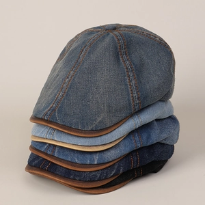 Detailed close-up showing five vintage denim flat caps in assorted blue and black washes