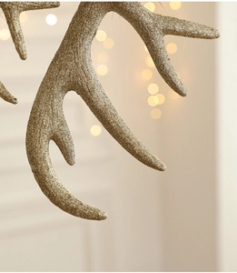 Macro shot of gold glitter texture on resin reindeer antler Christmas tree ornament