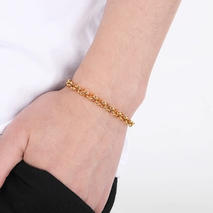 Close-up of 18k gold plated stainless steel rolo chain bracelet worn on wrist