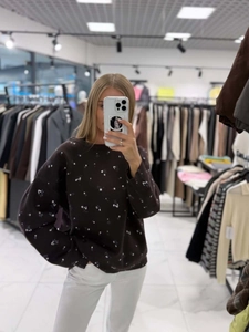Relaxed fit dark brown crewneck sweater with delicate white floral pattern knit details