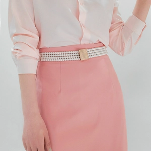 Detail of multilayer pearl waist chain with a sparkling gold square rhinestone buckle