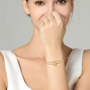 Detailed view of double-layered gold rope chain necklace with classic OT buckle closure