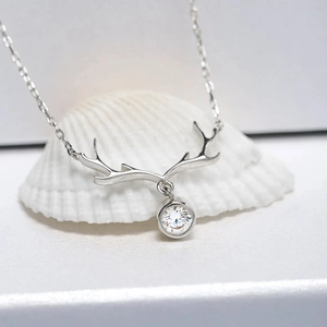 Detail view of silver reindeer antler necklace with a sparkling cubic zirconia stone
