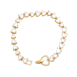 Macro detail of gold heart chain bracelet with cubic zirconia and heart-shaped clasp