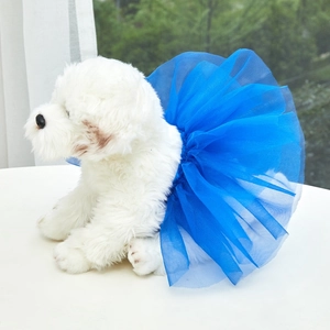 Detail of layered blue tutu skirt on a white dog showing mesh texture and volume